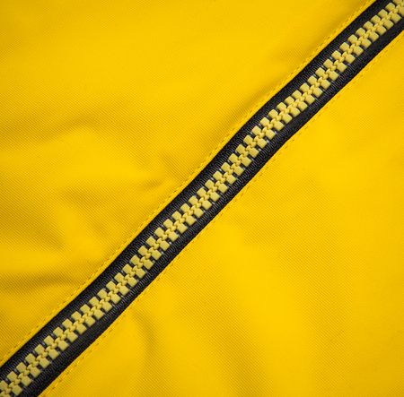 Close up zipper on a yellow background