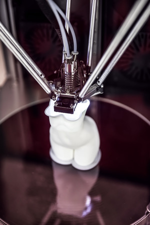 3D printer printing, also known as additive manufacturing (AM), refers to processes used to create a three-dimensional object in which layers of material are formed under computer control.の写真素材