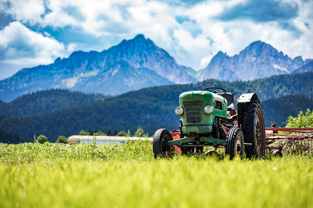 Old tractor in the Alpine meadowsの写真素材