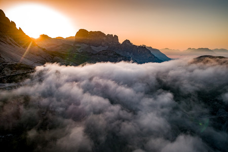 National Nature Park Tre Cime In the Dolomites Alps. Beautiful nature of Italy. Aerial FPV drone flights at sunsetの写真素材