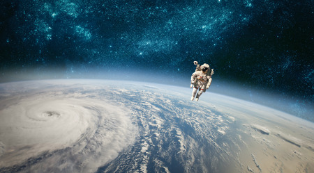 Astronaut in outer space against the backdrop of the planet earth.の写真素材
