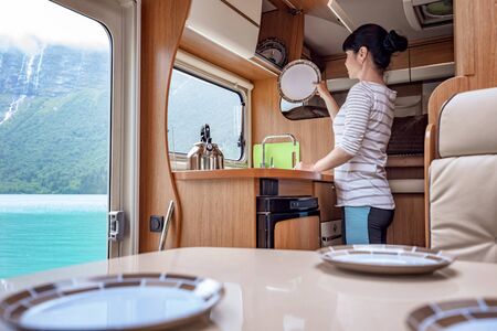Woman cooking in camper, motorhome RV interior.の写真素材