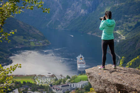 Geiranger fjord, Beautiful Nature Norway panorama. Nature photographer tourist with camera shoots.の写真素材