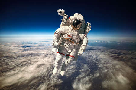 Astronaut in outer space against the backdrop of the planet earth.