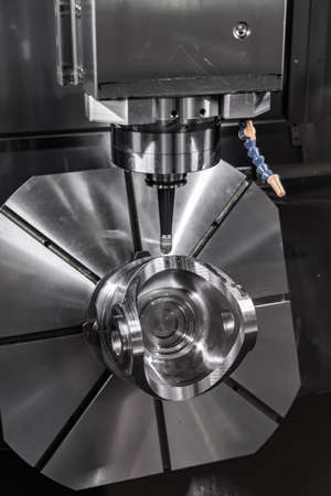 Metalworking CNC milling machine. Cutting metal modern processing technology. Small depth of field. Warning - authentic shooting in challenging conditions. A little bit grain and maybe blurred.の写真素材