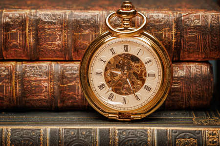 Vintage Antique pocket watch on the background of old books