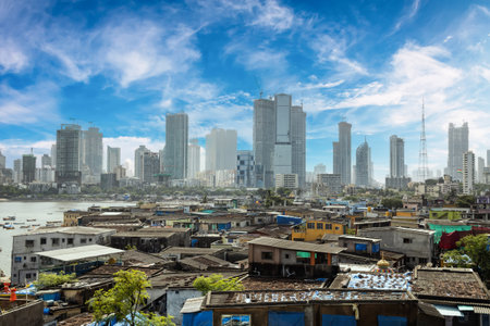 Views of slums on the shores of Mumbai, India against the backdrop of skyscrapers under...