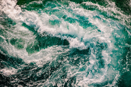 Blue waves of water of the river and the sea meet each other during high tide and low tide. Whirlpools of the maelstrom of Saltstraumen, Nordland, Norway.の写真素材