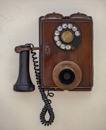 Old Antique Retro phone on a white wall...の写真素材