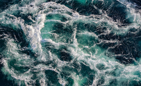 Blue waves of water of the river and the sea meet each other during high tide and low tide. Whirlpools of the maelstrom of Saltstraumen, Nordland, Norway.の写真素材