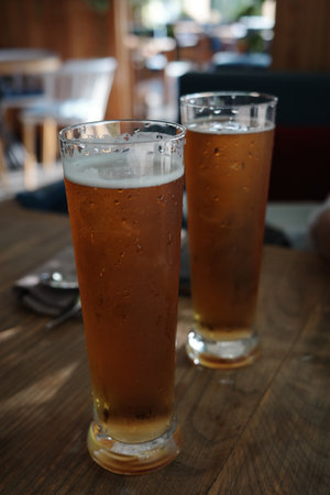 Glasses of light beer with at bar.の写真素材