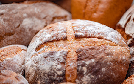 Freshly baked natural bread is on the kitchen table.