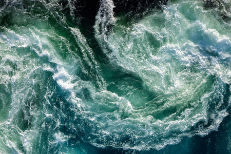 Blue waves of water of the river and the sea meet each other during high tide and low tide....
