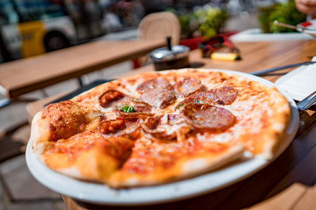 Pizza on the table of a street cafeの写真素材