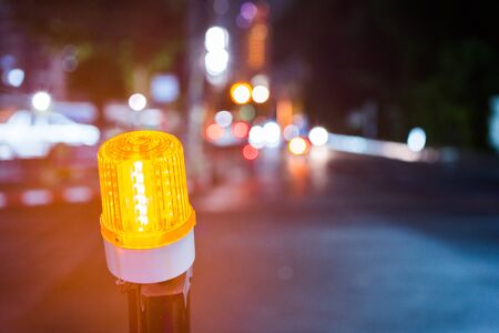 Indicator light of construction zone on the road of the night city.の写真素材