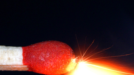 Closeup macro the head matchstick begins to erupt spark.の写真素材