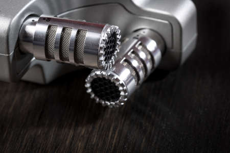 Shiny chrome x/y stereo microphone against dark backgroundの写真素材