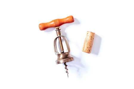 A wine cork and a vintage corkscrew, shot from the top on a white backgroundの写真素材