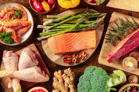 Food banner. Meat, poultry, fish and seafood, fruit and vegetables, legumes, mushrooms, and nuts, shot from the top on a dark rustic wooden backgroundの写真素材
