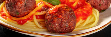 Meatballs with spaghetti close-up panorama, with vibrant tomato sauceの写真素材