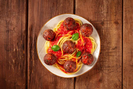 Meatballs with spaghetti, tomato sauce, and basil, shot from the topの写真素材