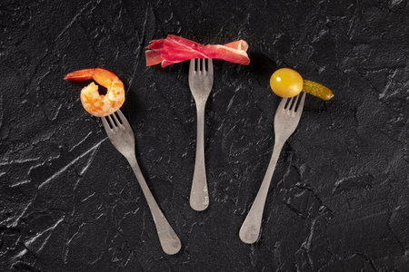 Wine snacks, overhead flat lay shot on a black background