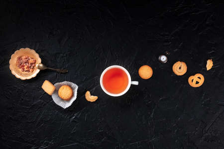 Danish butter cookies with a cup of tea, overhead flat lay composition