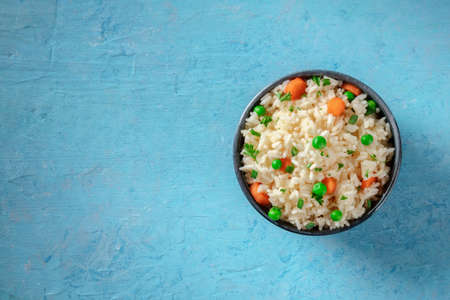 Rice with green peas, carrots, and spring onions, overhead shotの写真素材