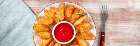 Baked potato wedges panorama with a fork and a napkinの写真素材