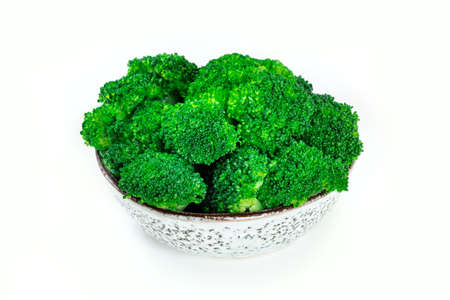 Boiled broccoli in a bowl, isolated on a white background