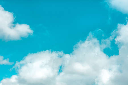 Blue sky with fluffy clouds on a windy day in spring. Abstract template with copy spaceの写真素材