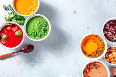 Vegan soup overhead flat lay banner with copy space, fresh spring and summer detox menu. Green, red,...