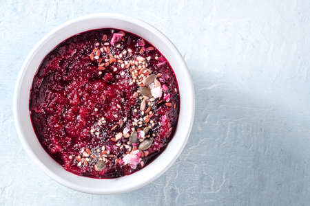 Chilled beet soup, healthy vegan detox diet. Beetroot puree with seeds, summer lunch, shot from the...