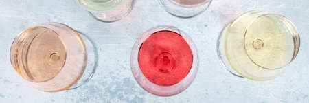 Rose and white wine, overhead flat lay panorama with a place for text. Winetasting event, elegant glassesの写真素材