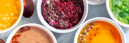 Healthy vegan cream soups panorama, vegetable detox banner, overhead flat lay shot of an assortment of dishesの写真素材