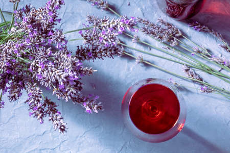 A glass of rose wine with lavender flowers, overhead flat lay shot with summer shadows. Vin de Provenceの写真素材