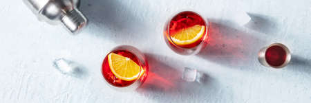 Cocktail with fresh oranges, a jigger and a cocktail shaker, overhead flat lay panorama, summer party panoramic bannerの写真素材