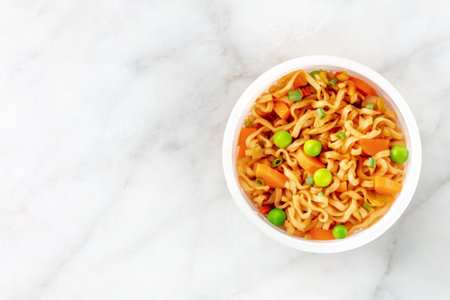 Ramen cup, instant soba noodles in a plastic cup with vegetables, shot from the top with copy spaceの写真素材