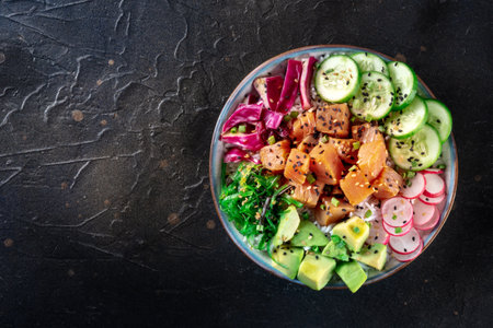 Tuna poke bowl with avocado, cucumbers, wakame, radish, and purple cabbage, a healthy Hawaiian dish...