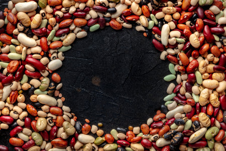 Legumes texture. Pulses banner design with copy space. Many different beans and grains, overhead...
