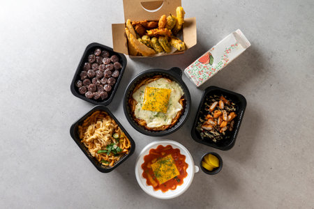 Fish cake soup, tteokbokki, spicy potato pancake, red pepper fries, cheese, potatoes, flying fish roe, rice balls, tuna, mayonnaise, chickenの写真素材