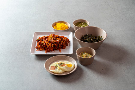 Korean food dish stir-fried cartilage rice ball, seafood fish cake soup, boiled pork, tofu, kimchi, and stir-fried porkの写真素材