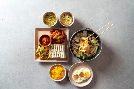 Korean food dish stir-fried cartilage rice ball, seafood fish cake soup, boiled pork, tofu, kimchi, and stir-fried porkの写真素材