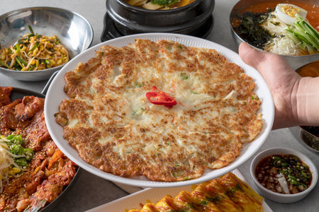 Korean food dish Grilled pork kimchi, potato pancake, egg roll, kimchi roll noodles, bibim noodles, side dishesの写真素材