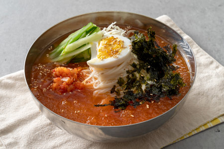 Korean food dish Grilled pork kimchi, potato pancake, egg roll, kimchi roll noodles, bibim noodles, side dishesの写真素材