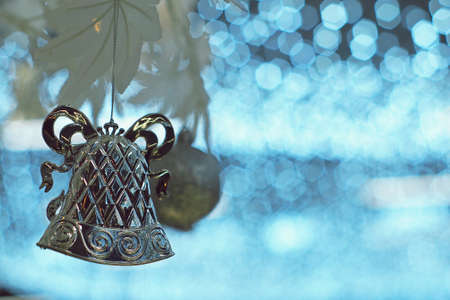 Christmas silver bell and ball ornament on artificial white treeの写真素材