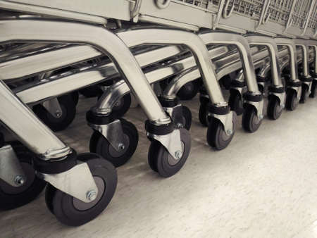 Group of shopping cart trolley wheel on white floorの写真素材