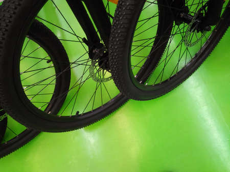 Wheeled bicycle parked on the green ground,row of bicyclesの写真素材