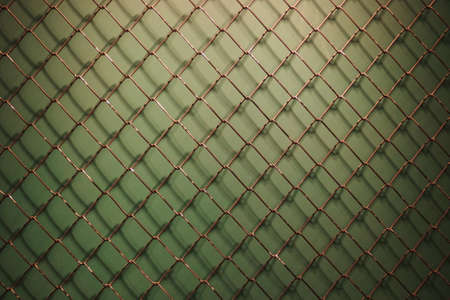 blank Metal Fence net mesh on dark green plain background with shadowの写真素材