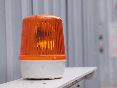 orange siren light in construction side on safety sign